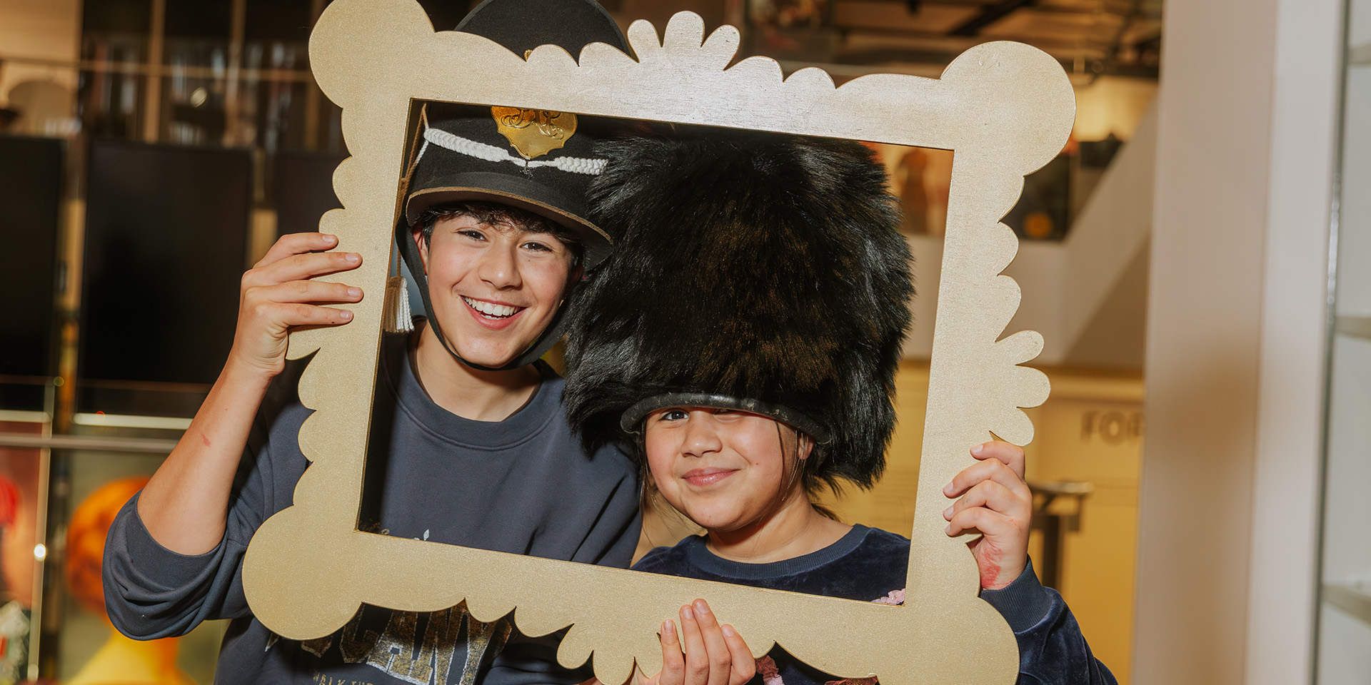 Children posing for a photo in military headwear