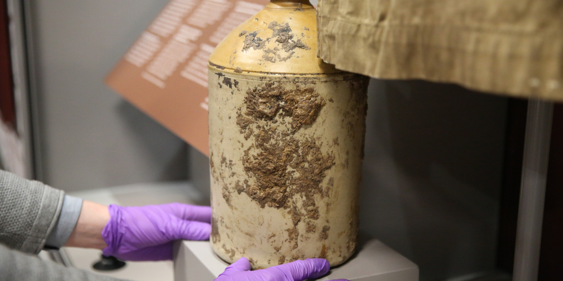 Installing a First World War rum jar in the Conflict in Europe gallery