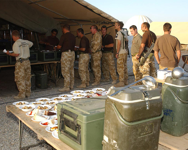 Soldiers tuck in to their evening meal at Camp Bastion, Afghanistan, 2006