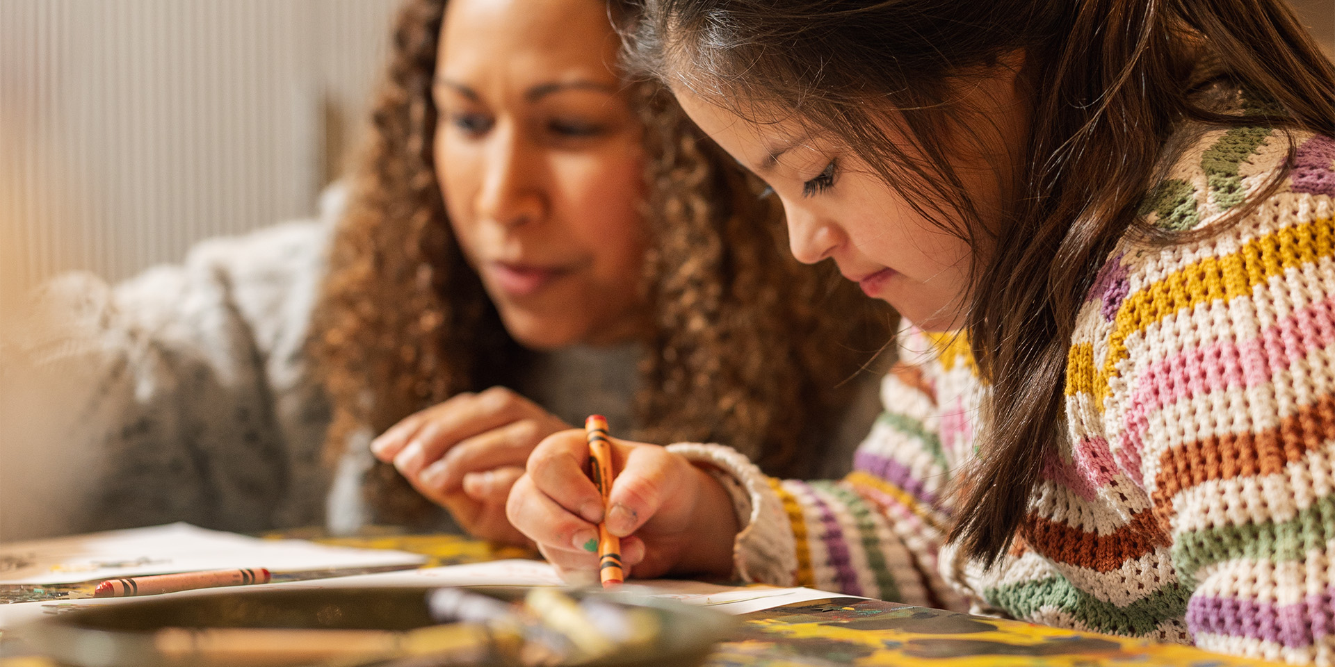 Family doing some colouring in with crayons