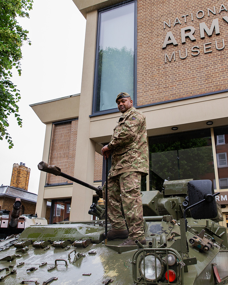WO1 Johnson Beharry with the Warrior armoured vehicle outside the National Army Museum