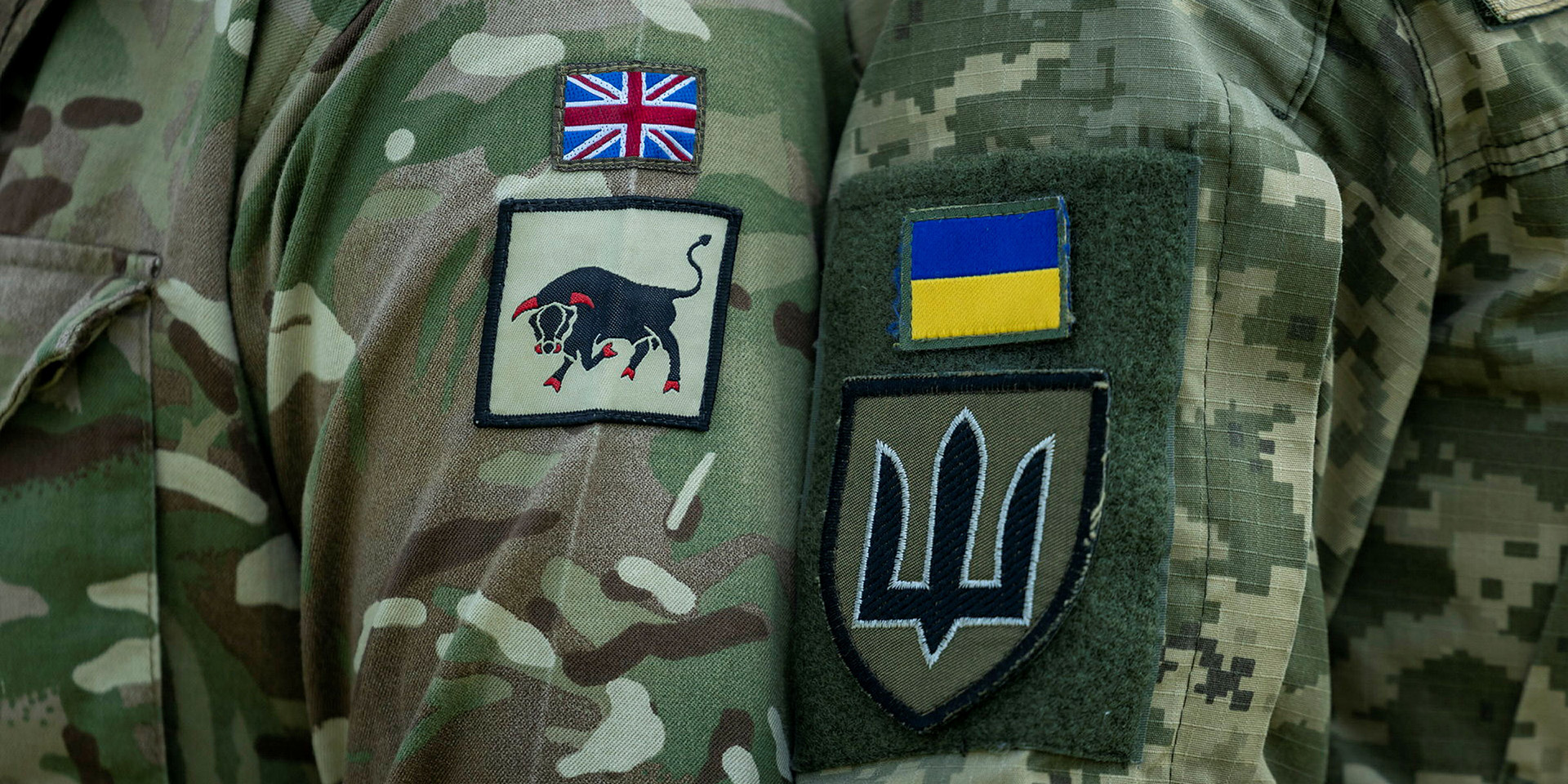 British and Ukrainian soldiers display their unit identification patches during joint training
