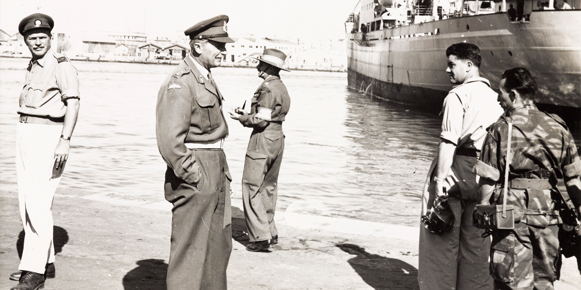 Lieutenant General Sir Hugh Charles Stockwell, leader of the Anglo-French ground forces in the Suez Operation, with reporters and photographers on a quayside in Egypt, 1956