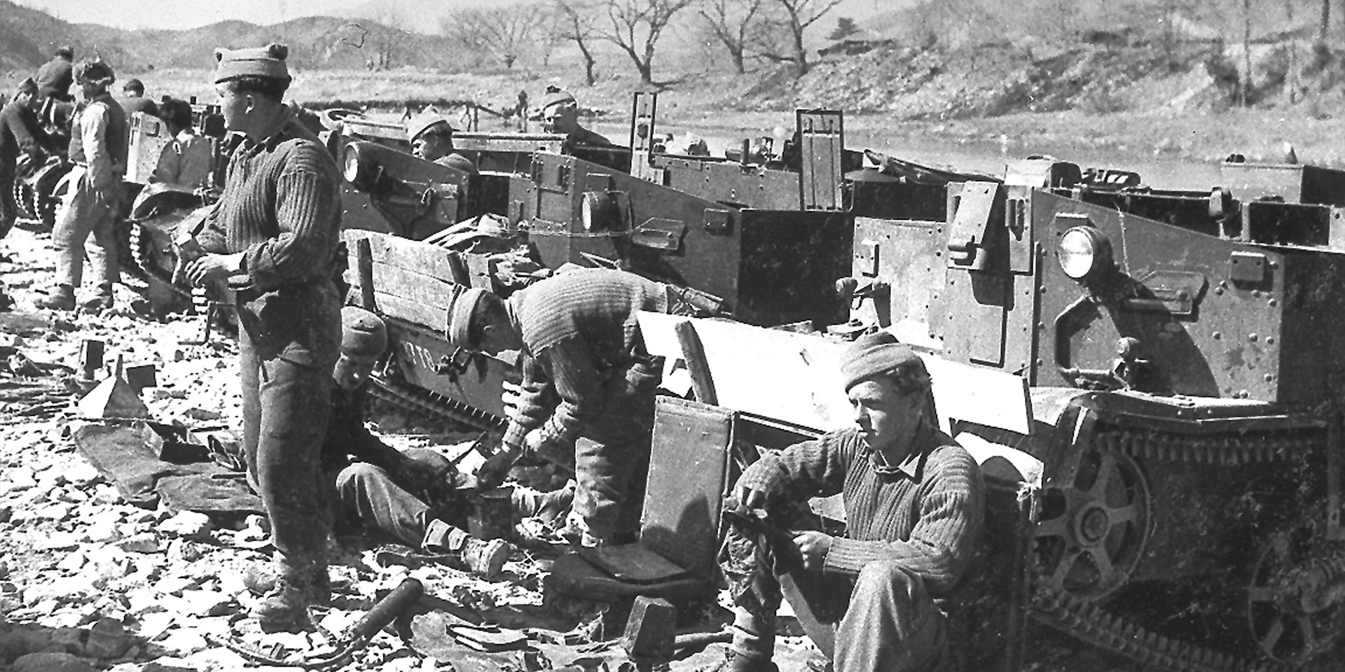 Members of 1st Battalion The Middlesex Regiment (Duke of Cambridge’s Own) rest next to their carriers in Korea, 1950