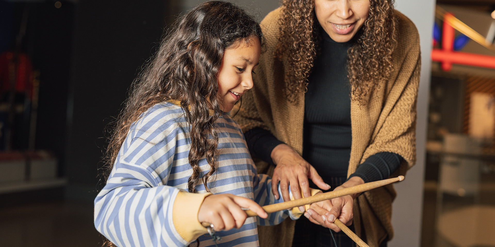 Child attending a family drumming workshop