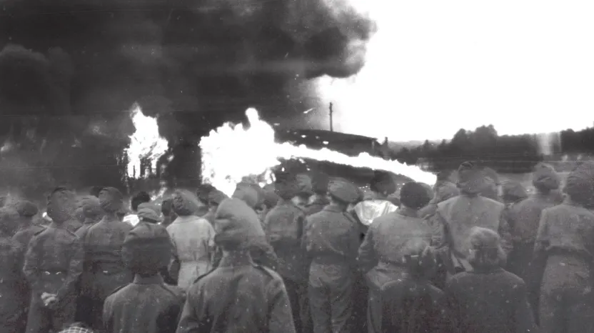 British soldiers and locals watch the burning of Belsen, May 1945