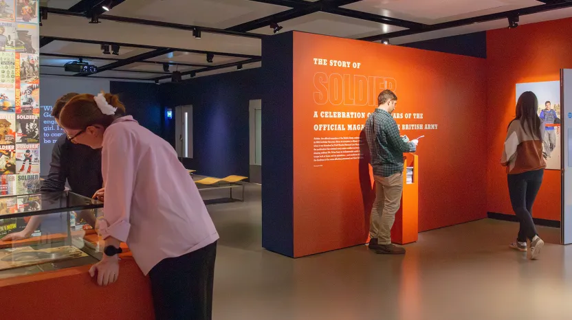 Visitors in 'The Story of Soldier Magazine' display