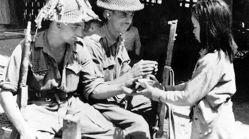 Soldiers of 2nd Battalion, The Royal Berkshire Regiment, with a local girl in Burma, 1945