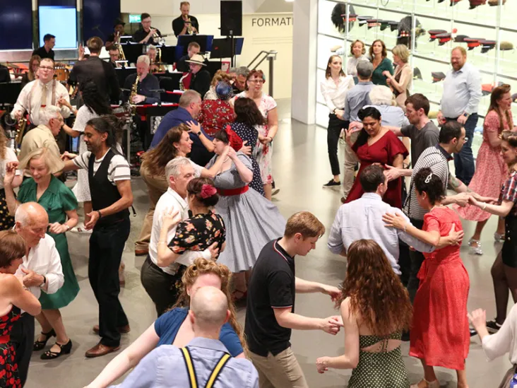 People dressed in 1940s style dancing at the National Army Museum