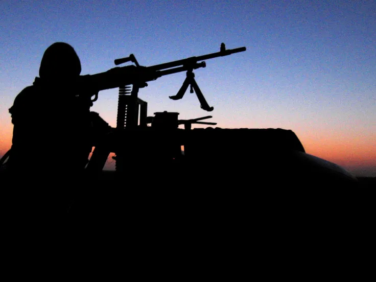 An SAS soldier aims a light machine-gun, c2005