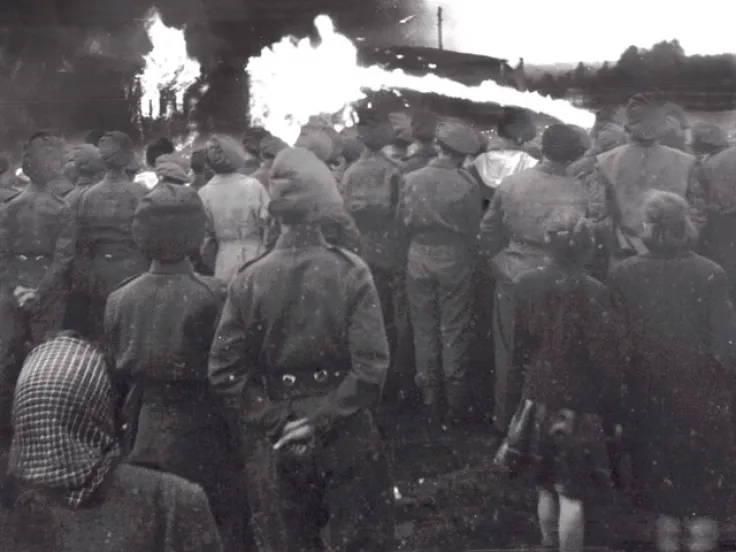 British soldiers and locals watch the burning of Belsen, May 1945