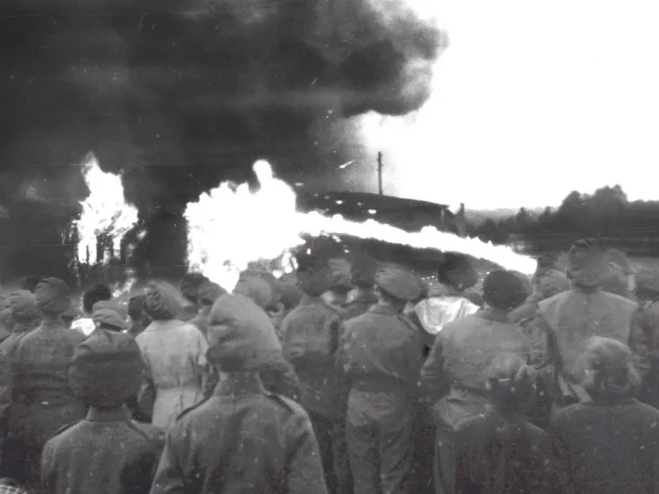 British soldiers and locals watch the burning of Belsen, May 1945