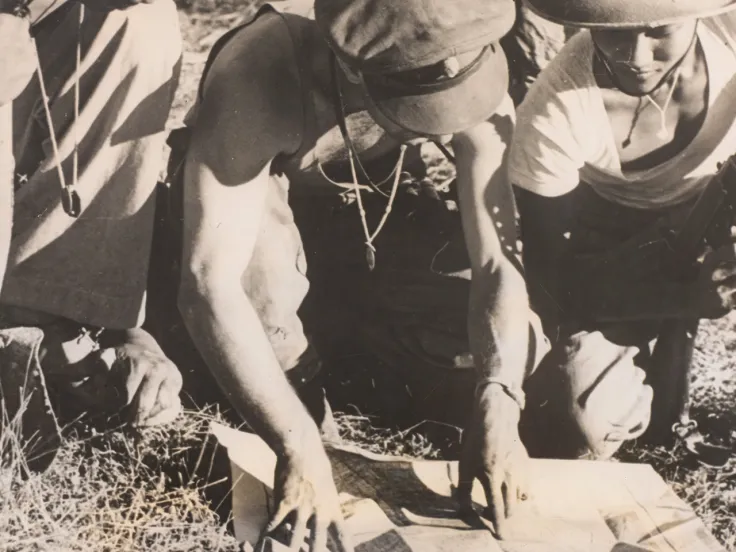 A British Commando officer confers with Burmese soldiers, Arakan, Burma, 1944