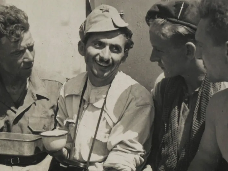 Men of No 2 Commando drinking tea with a Yugoslav partisan, 1944