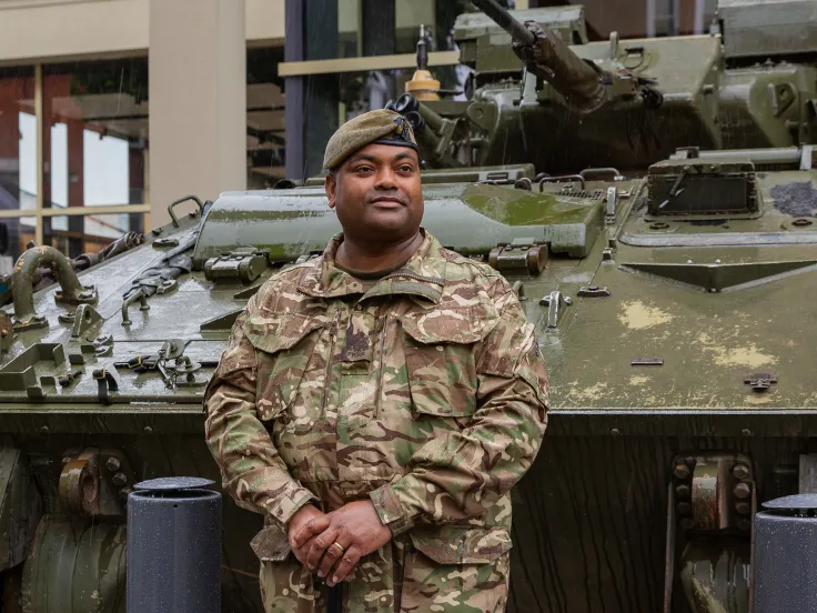 WO1 Johnson Beharry with the Warrior armoured vehicle outside the National Army Museum