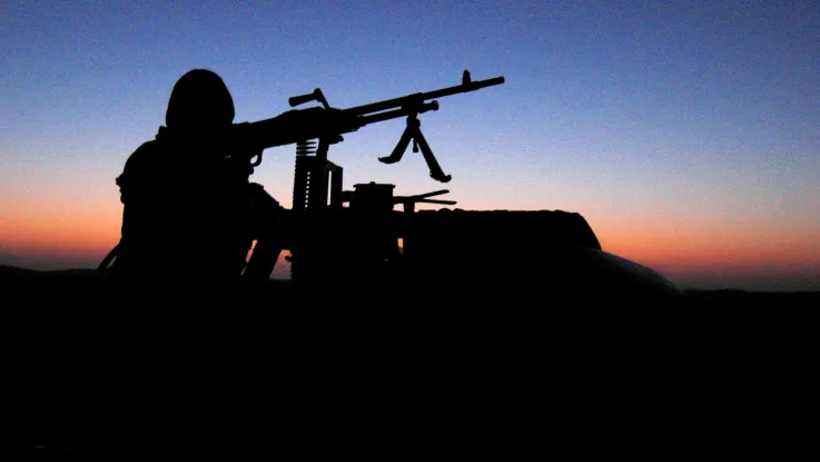 An SAS soldier aims a light machine-gun, c2005