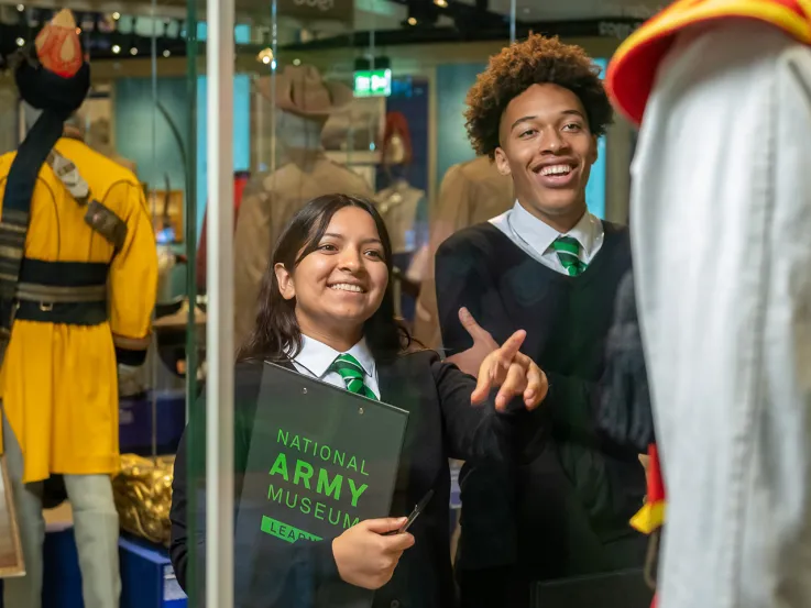 School children looking at uniforms in the Global Role gallery