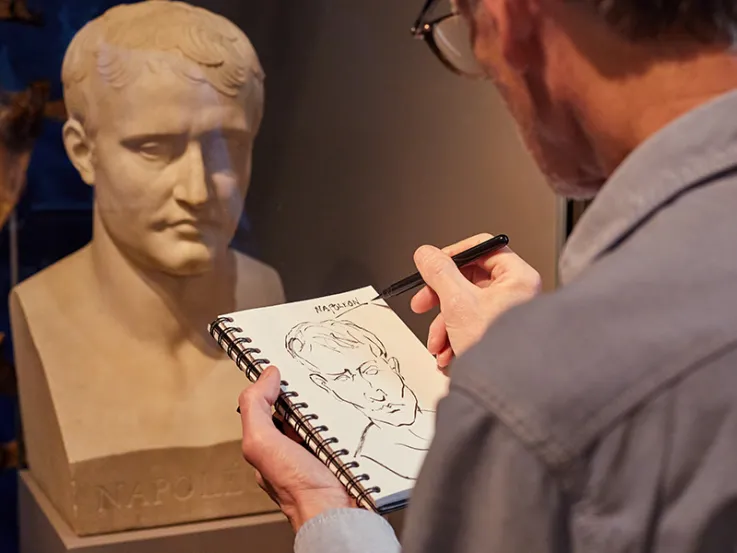 A visitor sketching a bust of Napoleon