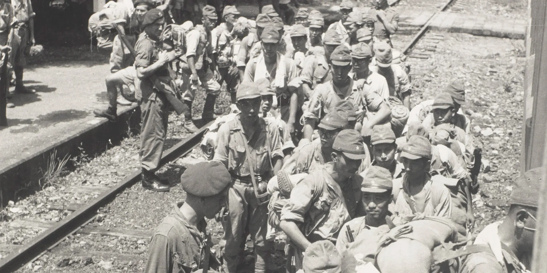 3rd Commando Brigade escorts captured Japanese soldiers in the Fanling district of Hong Kong onto a train bound for Kowloon, 15 September 1945