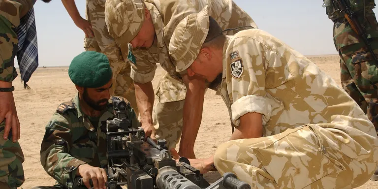 Members of The Parachute Regiment demonstrate the .50 Cal Browning machine gun to Afghan National Army soldiers, 2006