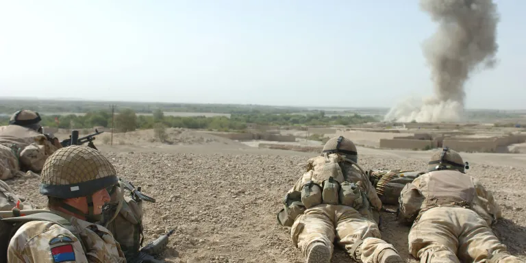 British soldiers watching the after effects of a 500lb bomb dropped on an enemy position in Musa Qala during the withdrawal of the garrison’s Danish contingent, 24 August 2006