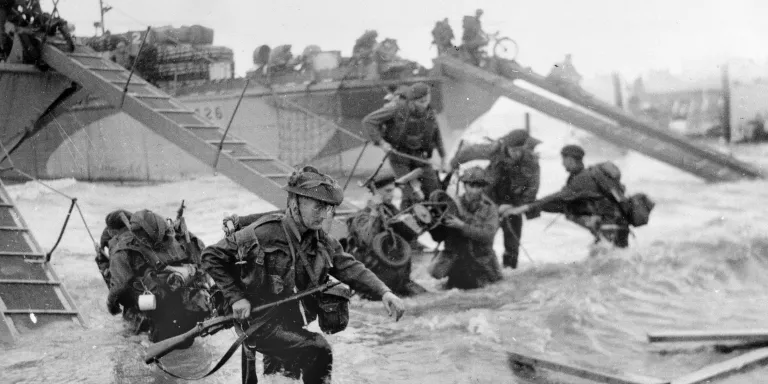 Troops wading ashore from landing craft, 6 June 1944