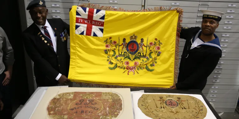 Workshop participants with their replica of the 4th West India Regiment flag