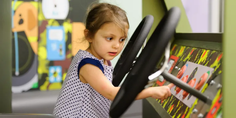 A child on the Play Base command vehicle