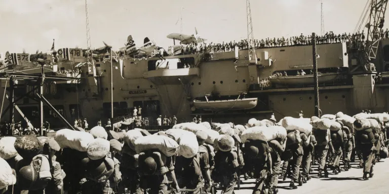 British troops board HMS Unicorn at Hong Kong for the voyage to Korea, 25 August 1950