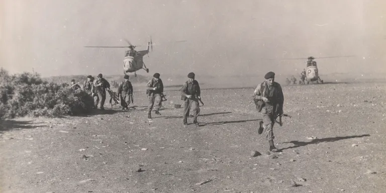 Troops disembark from helicopters, 1964