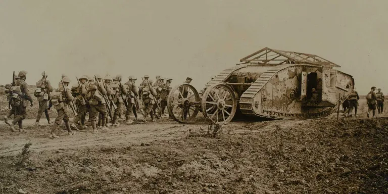Mark I tank C19 'Clan Leslie' in Chimpanzee Valley with infantry following behind during the Battle of Flers Courcelette, 15 September 1916