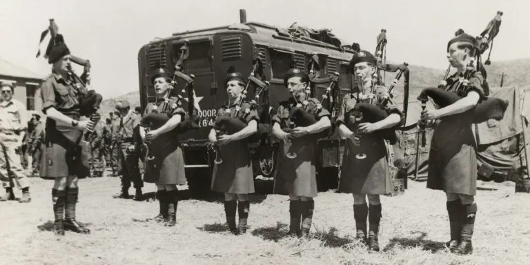 Royal Ulster Rifles pipers playing at the ceremony to award the Gloucestershire Regiment and 170th Independent Mortar Battery the US Presidential Unit Citation, 8 May 1951 