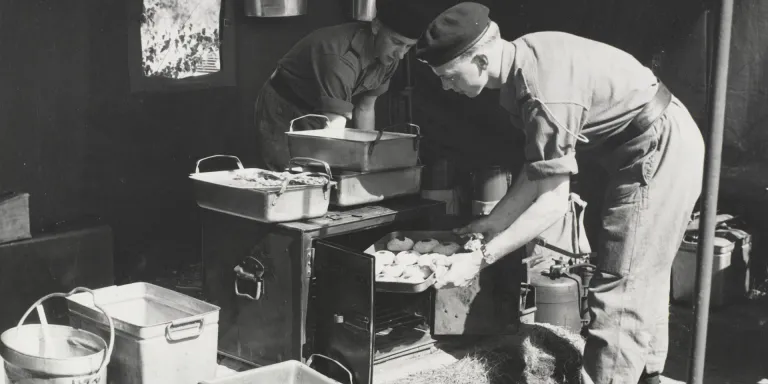 Army Catering Corps soldiers prepare a meal in a field kitchen, c1958