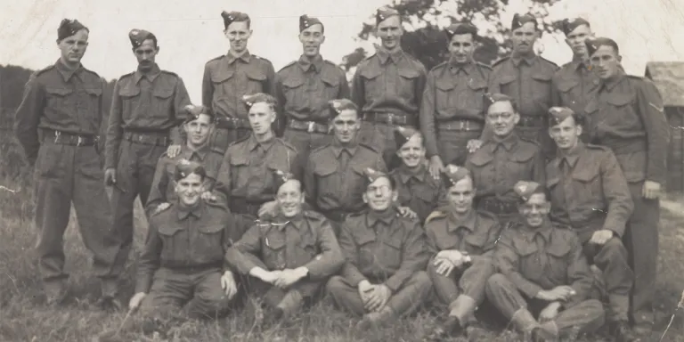 Private Abram Games (seated far right of middle row) with soldiers of The Royal Warwickshire Regiment, 1940