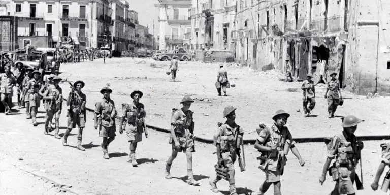 Soldiers of the Northamptonshire Regiment entering the town of Adrano, Sicily, August 1943