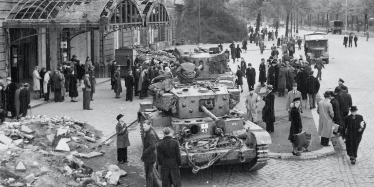 Civilians gather around British tanks outside Hamburg rail station, May 1945