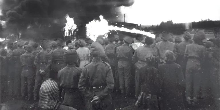 British soldiers and locals watch the burning of Belsen, 2 May 1945
