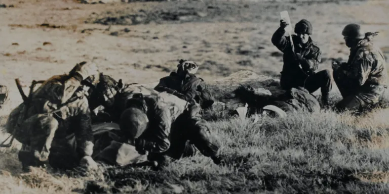 Paramedics attending a wounded Argentine soldier under fire, Mount Longdon, Falkland Islands, 1982