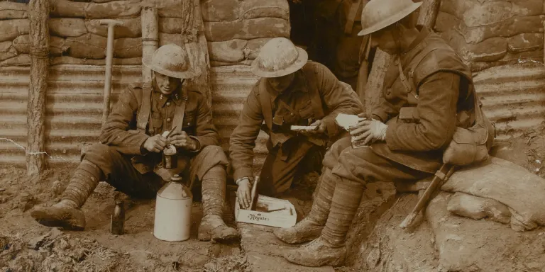 Soldiers eating and drinking in a trench, c1917